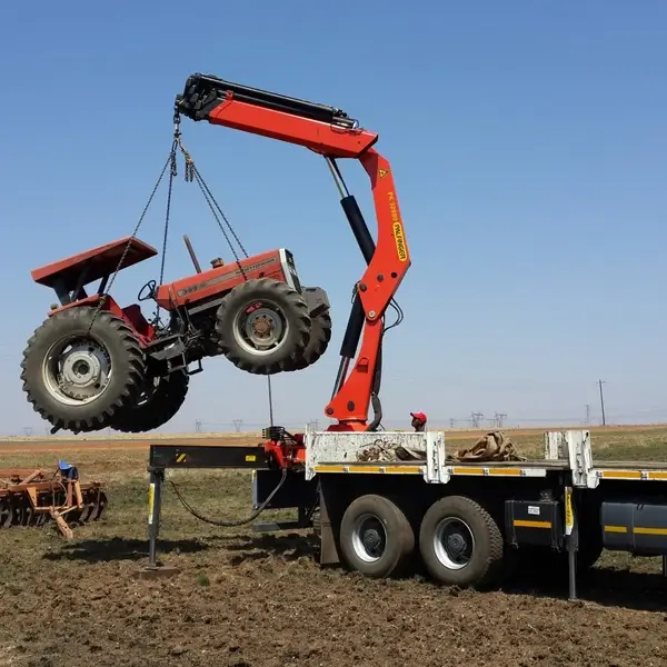 Crane Truck Lifting a Tractor Crane Truck Lifting a Tractor